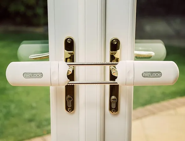 A secure lock system installed on a glass patio door, providing safety while maintaining a sleek and modern appearance.