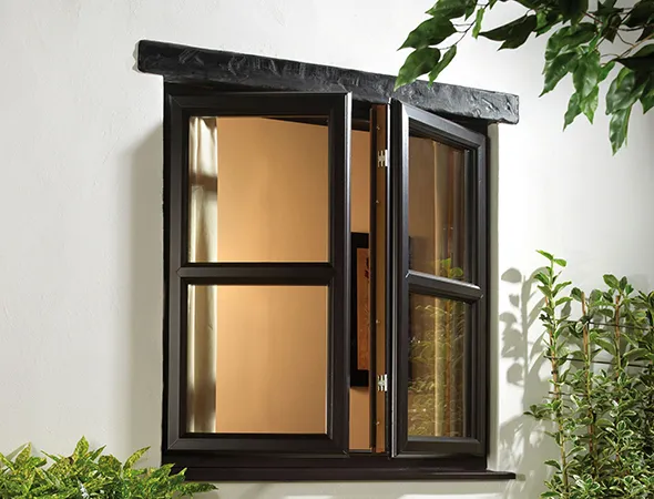 Open black-framed window on a white wall, bordered by green plants. Warm indoor light contrasts with outdoor greenery, creating a serene atmosphere.